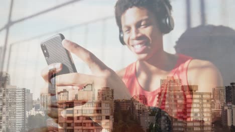 Animation-of-happy-african-american-man-wearing-headphones-over-cityscape