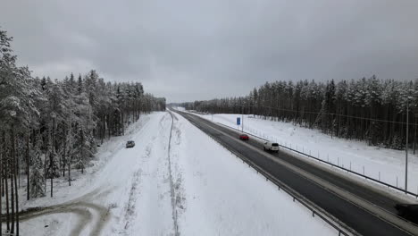 Typical-winter-motorway-national-road-in-Finland,-close-aerial-view