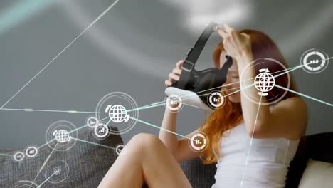 Animation-of-network-of-connections-with-icons-over-woman-wearing-vr-headset