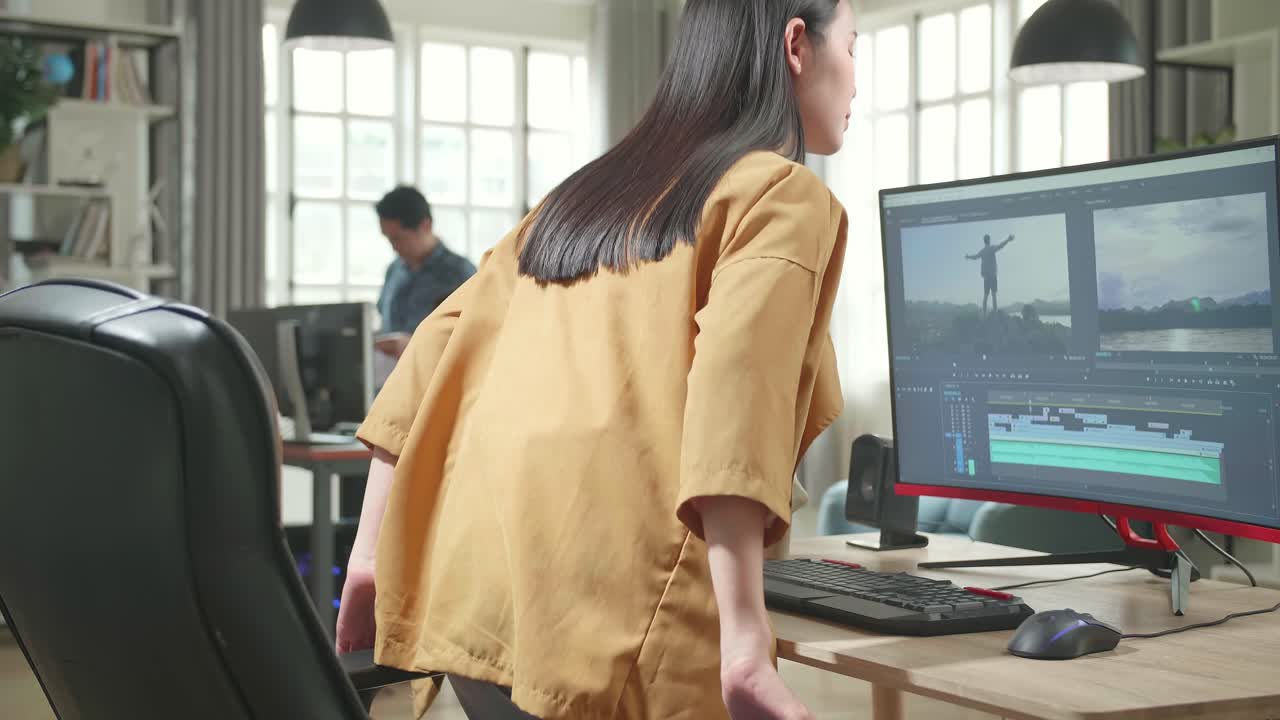 Asian Female Video Editor Start Works With Footage And Sound On Her Personal Computer In Office