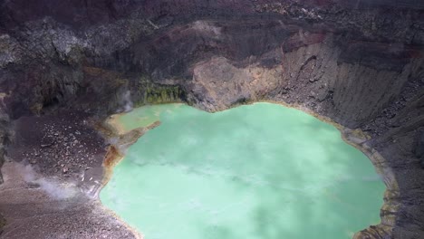 aerial view of steaming jade green crater lake in santa ana volcano