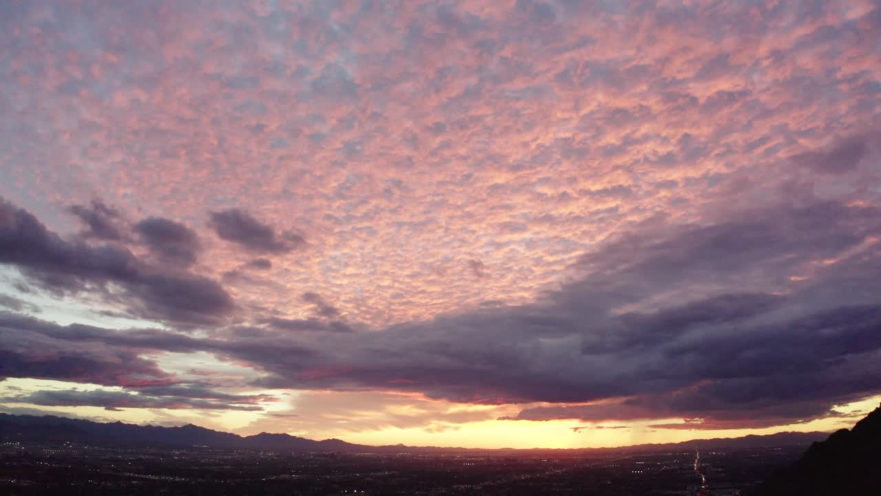 Tilting drone shot of the Arizona sunset revealing suburban neighborhoods
