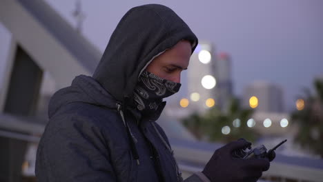 anonymous male watching drone surveillance display flying device in restricted area