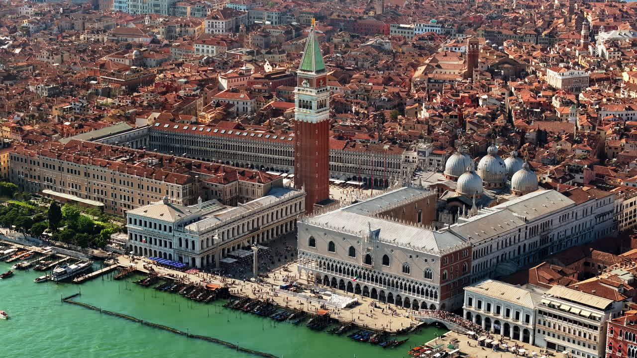 Aerial drone view of St. Mark's Square in Venice Italy, with the city on the background