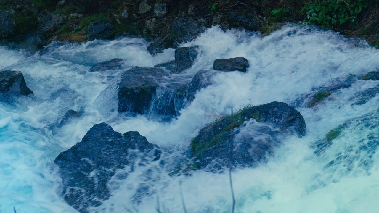 Immerse yourself in the pristine beauty of the Julian Alps with this stunning capture of a mountain river near Kranjska Gora, Slovenia. Crystal-clear turquoise water flows over smooth river rocks.