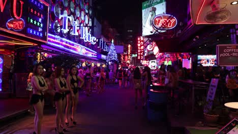 people enjoying vibrant nightlife with neon signs