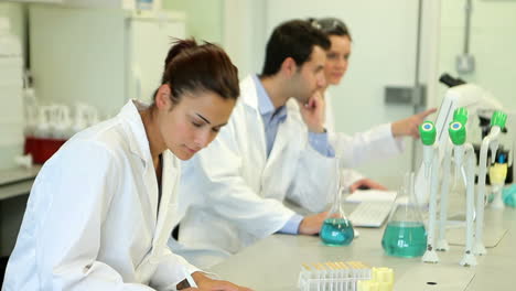 chemistry student looking up from her work and smiling