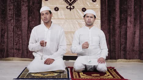 muslim people taking blessings of god using praying breads