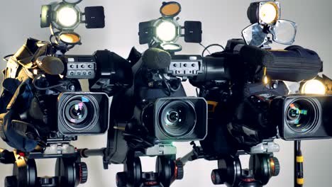tres cámaras de video en funcionamiento en un disparo de rotación lenta.