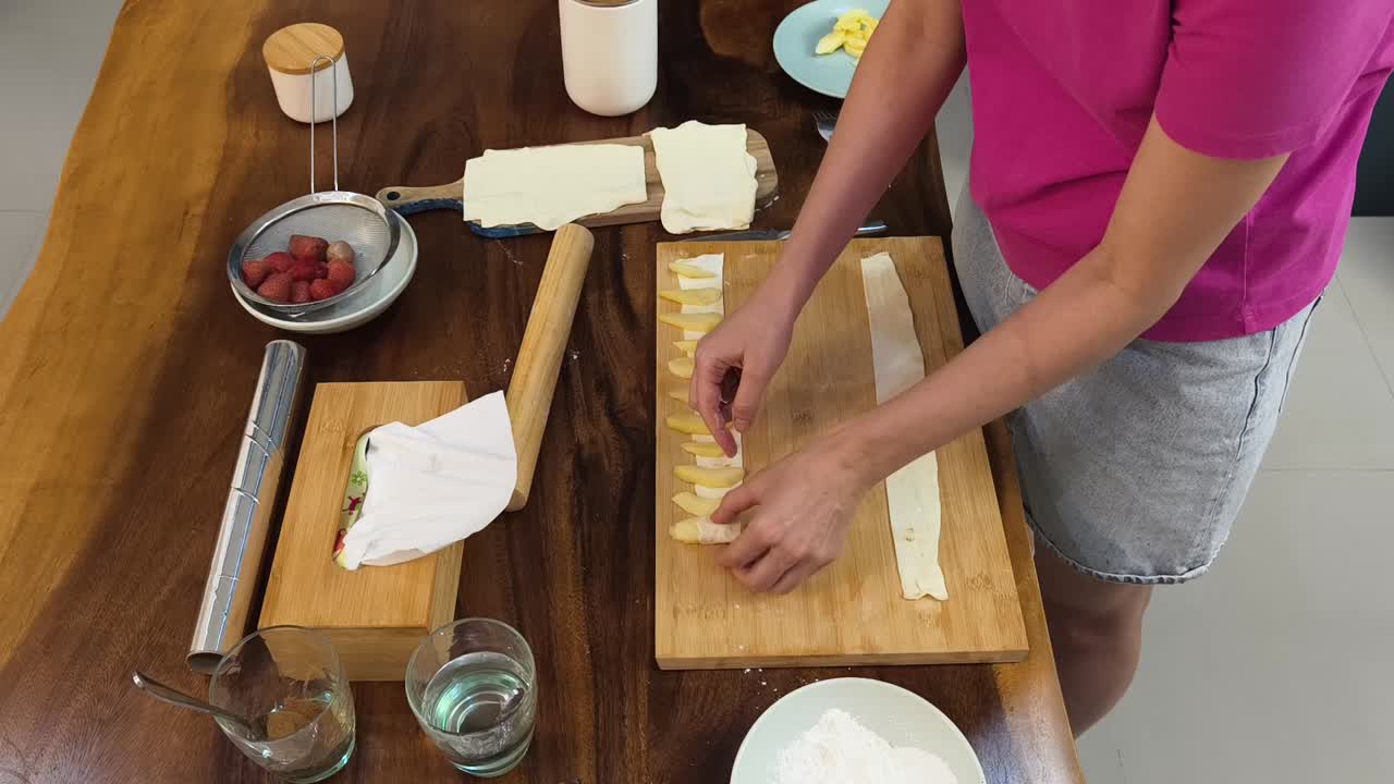 Preparing puff pastry with strawberries
