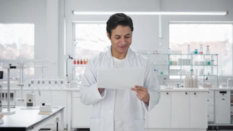 happy indian scientist reading research papers