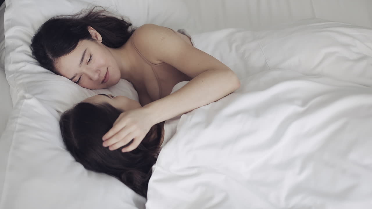 Two Women Sleeping in Bed
