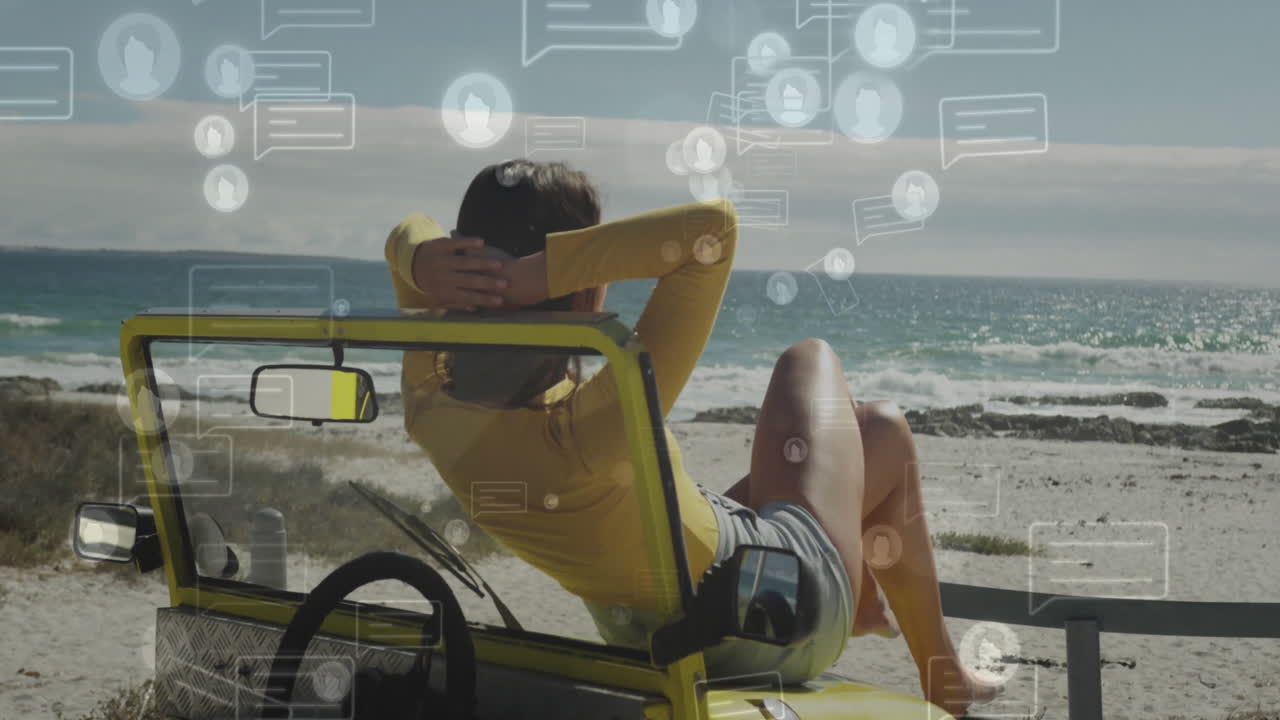 In yellow jeep by ocean, person relaxing with animation of social media icons