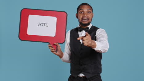 political bellboy hotelier showing a speech bubble with the message to vote