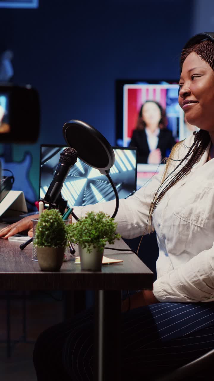 Vertical video Professional camera recording guest on internet podcast telling interesting story to journalist