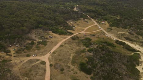 Vehicle-driving-on-unpaved-road-close-to-beach,-Punta-del-Diablo-in-Uruguay