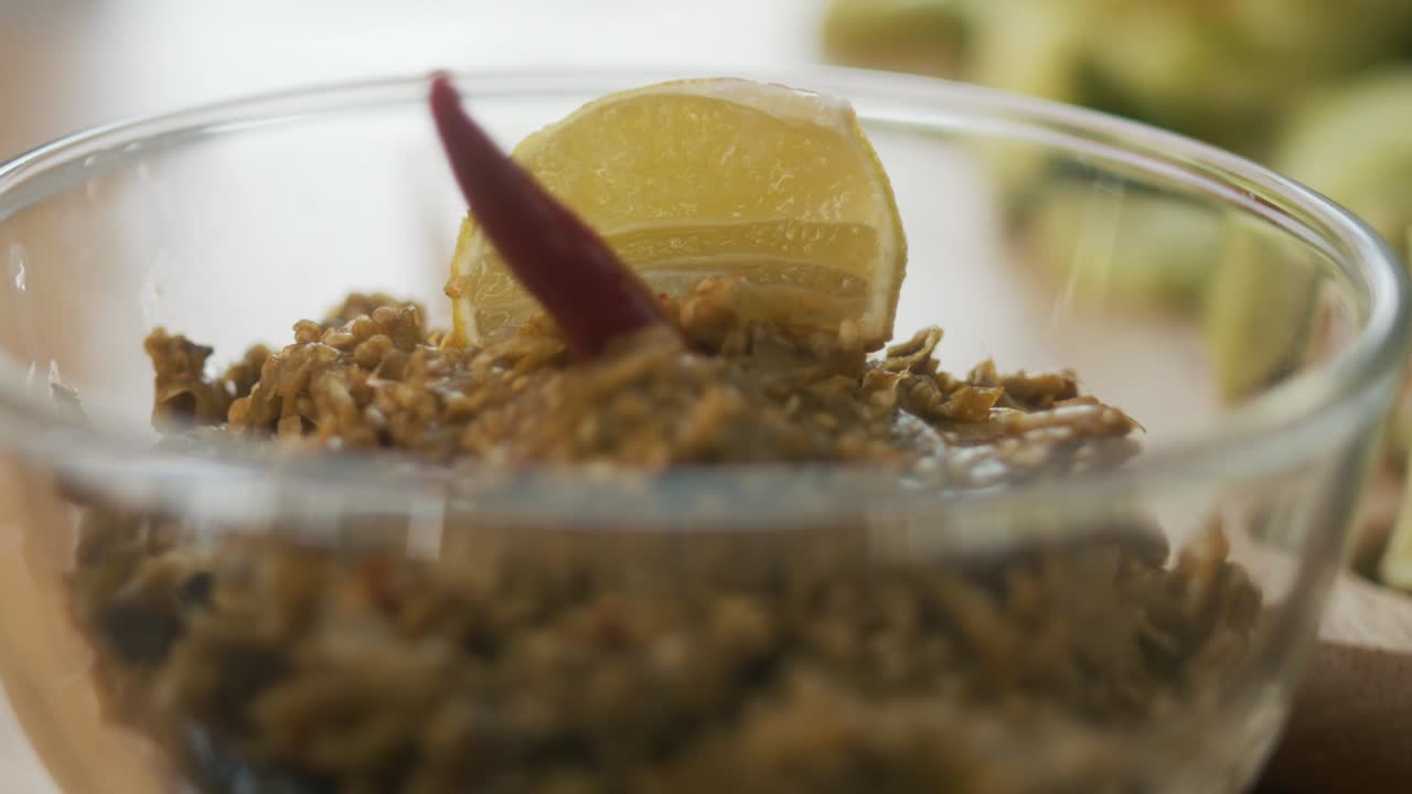 Freshly Made Green Salsa with Lime and Chilies in a Small Glass Bowl