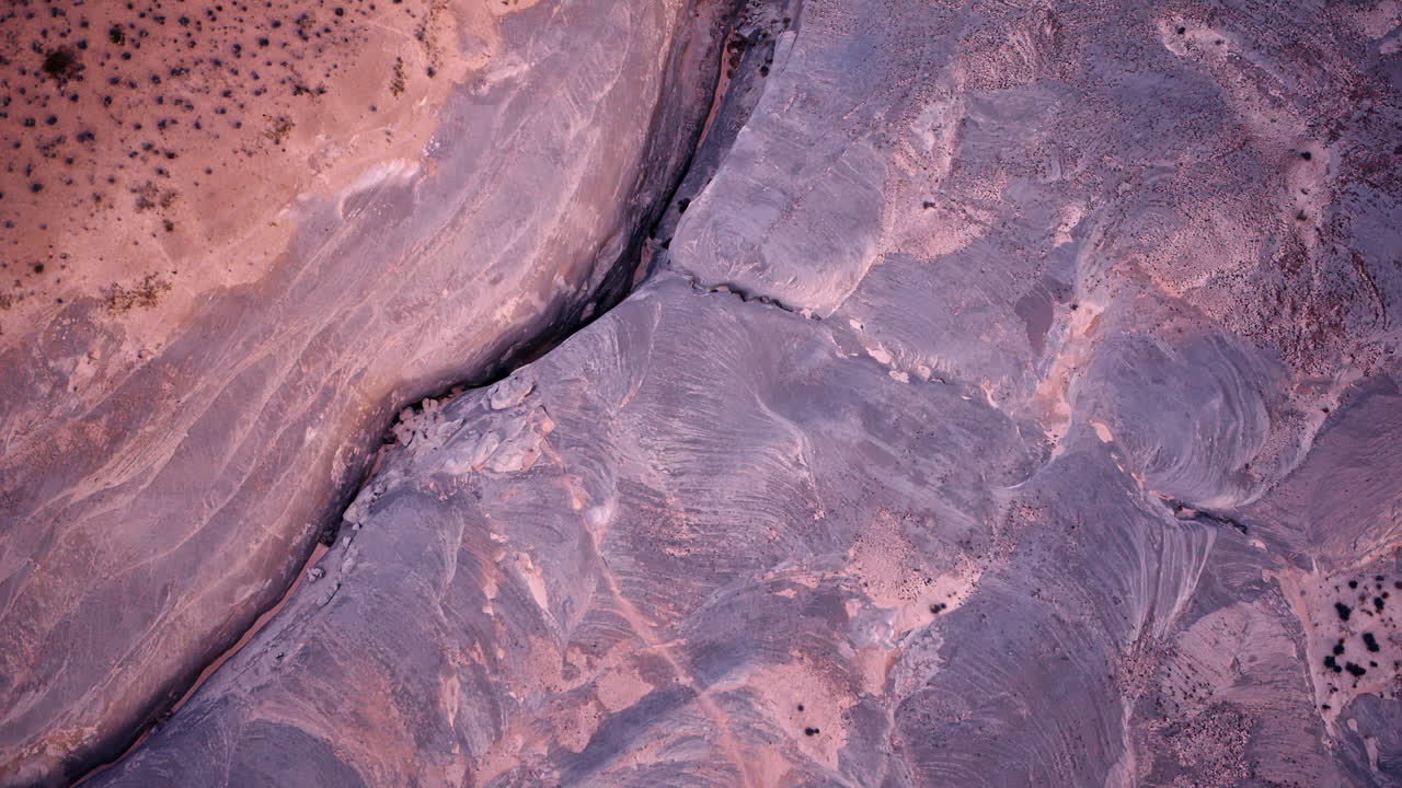 A panoramic aerial view capturing the rugged desert terrain and towering red cliffs near Lake Powell.