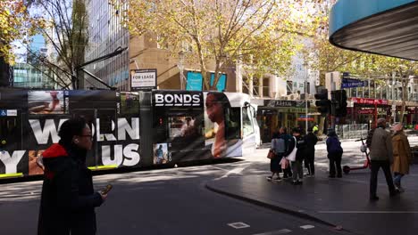 people walking near tram in melbourne street