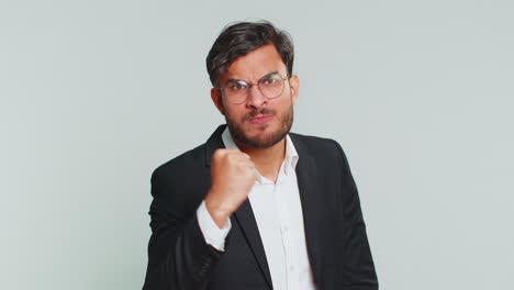 Aggressive-angry-Indian-man-trying-to-fight-at-camera,-shaking-fist,-boxing,-punishment,-threaten