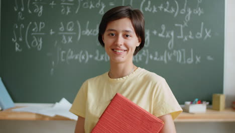 portrait of cheerful female student in classroom