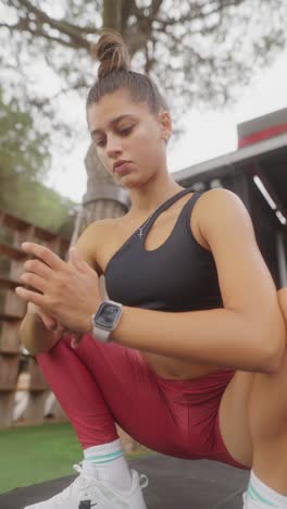 young woman exercising and stretching outdoors