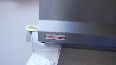 vacuum packaging machine for sealing the bag with medical tool. preparation of instruments for sterilization in the equipment.