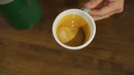 Professional-female-barista-makes-tulip-in-cappuccino---close-up