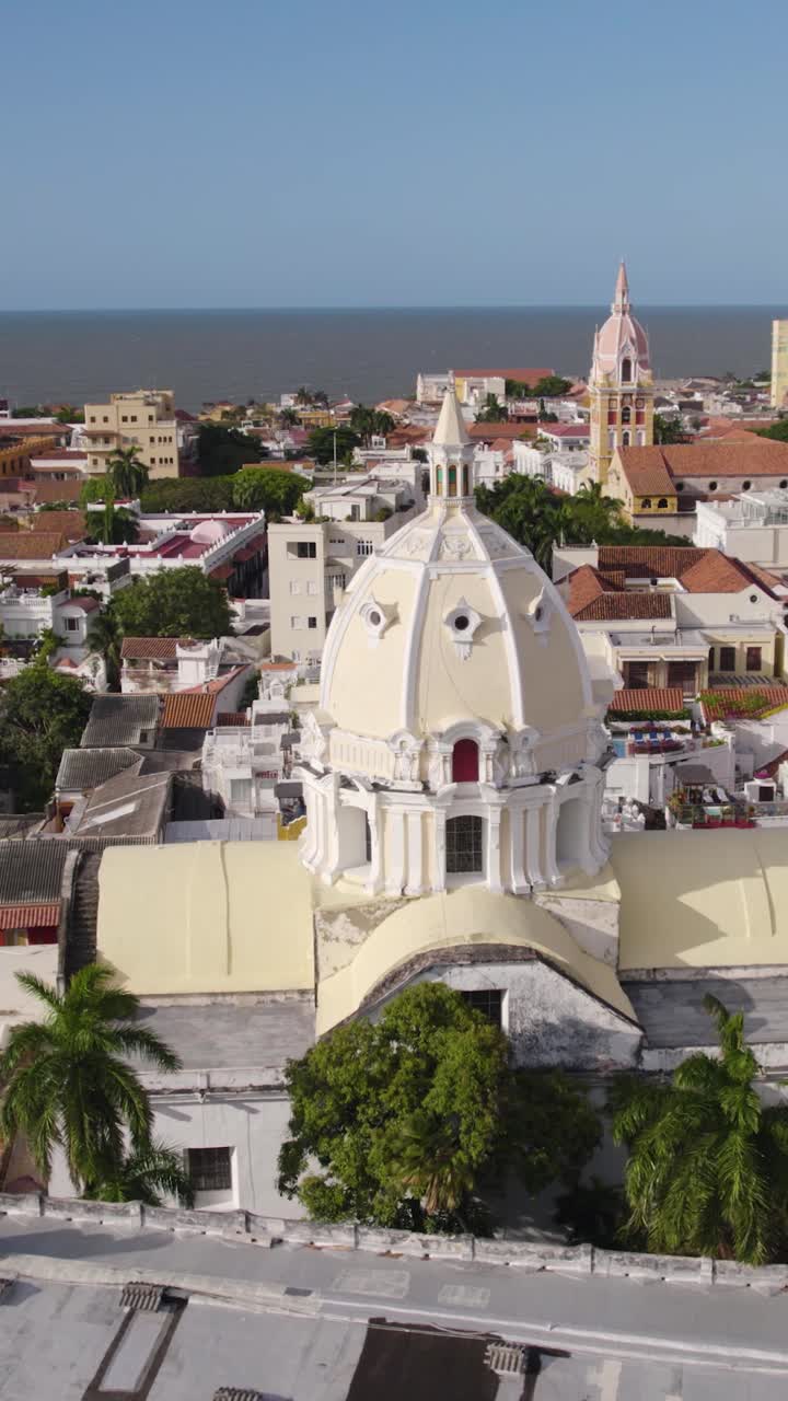 Aerial view of the intricate dome and architecture of San Pedro Claver Church in Cartagena, Colombia, showcasing its historical significance amidst the cityscape. Vertical Video