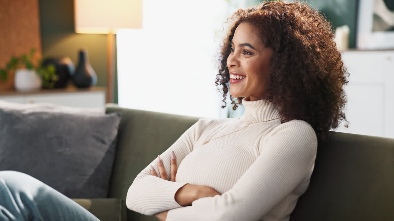 Woman using credit card and remote control at home