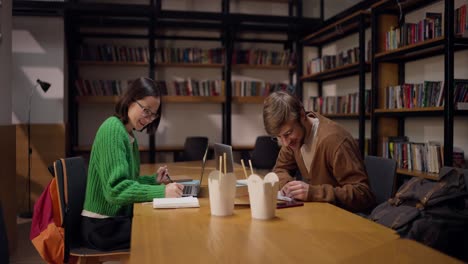 students studying in a library cafe