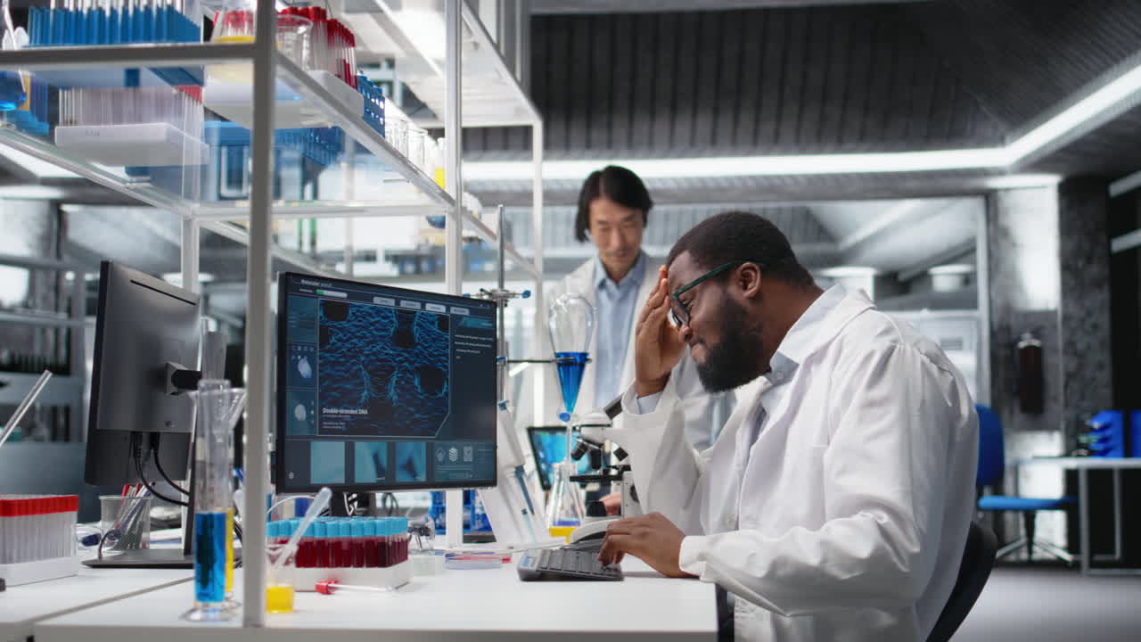 Vertical video Laboratory scientist squinting eyes at computer monitor, thinking