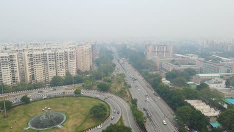 aerial drone shot offering a panoramic view of delhi’s flyovers packed with cars, auto-rickshaws, and public transport buses.