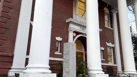 pov walking along pavement on church street past woodstock town hall in vermont