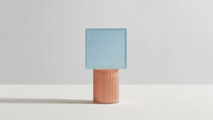 Rising camera revealing ribbed peach pedestal and matte blue square on white table, showing texture