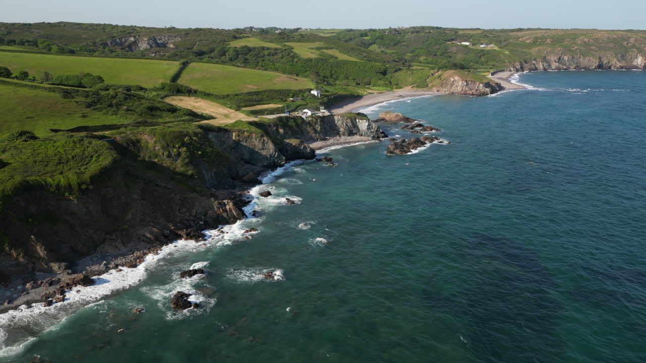 A drone view of the rugged coastline on the south coast of Cornwall, England near the village of Kuggar and Kennack Sands popular with holidaymakers.
