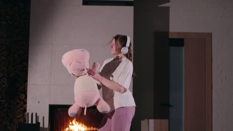 mother and daughter dancing near fireplace