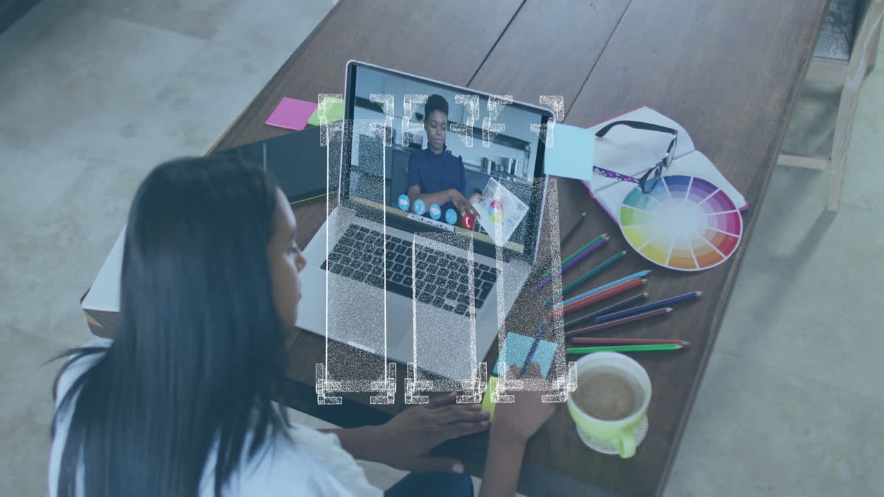 Woman working on laptop with digital data animation over creative workspace