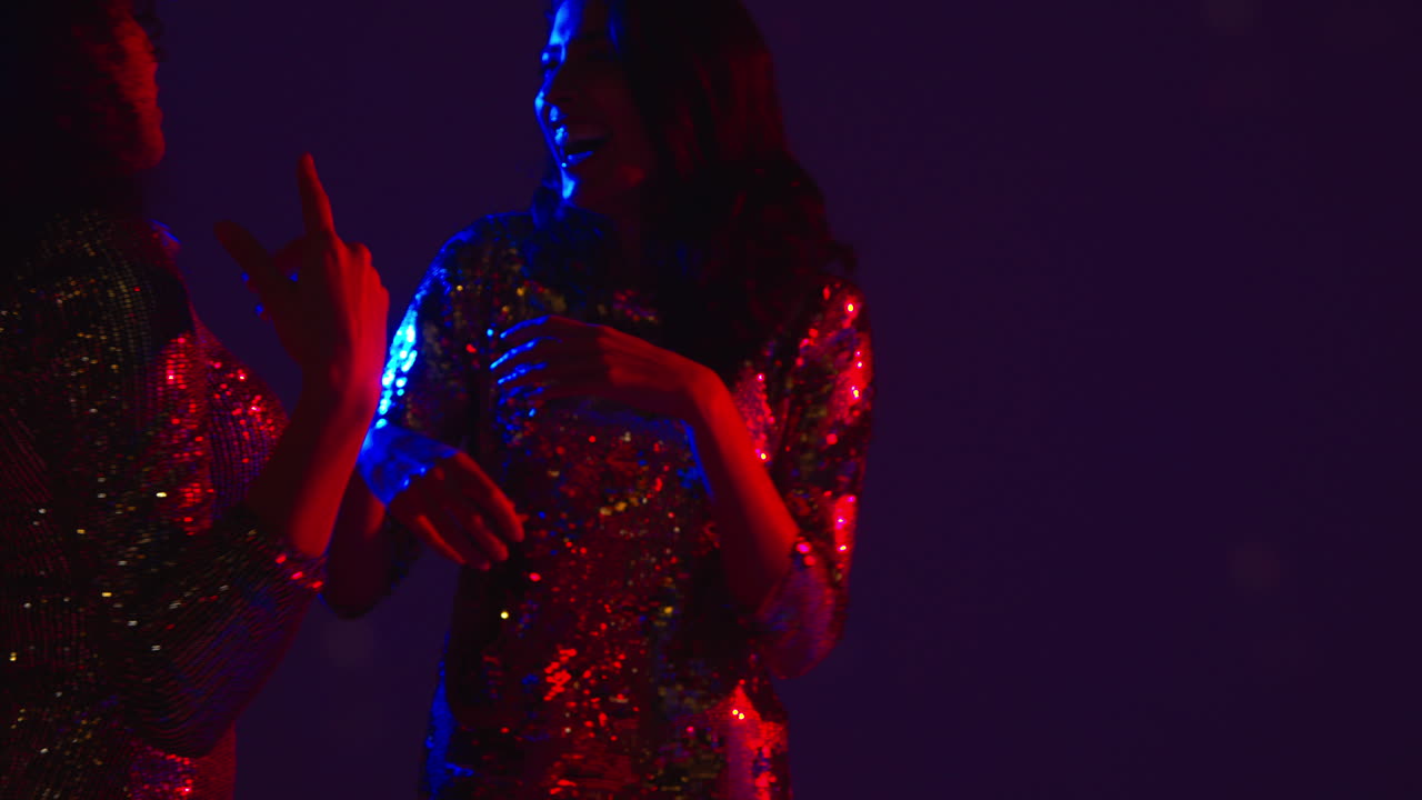 Close Up Of Two Women In Nightclub Bar Or Disco Dancing Talking And Having Fun Together 2