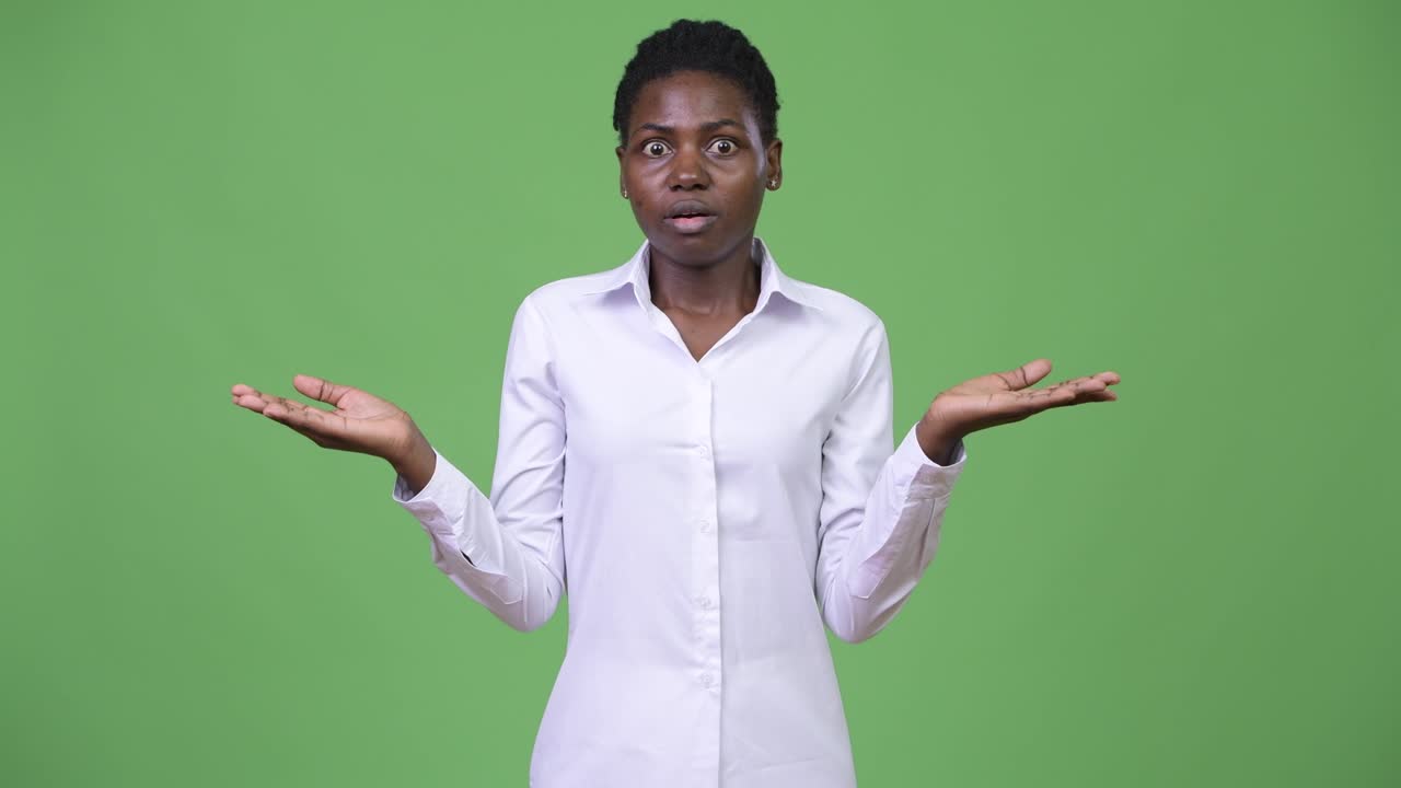 Young beautiful African businesswoman shrugging shoulders