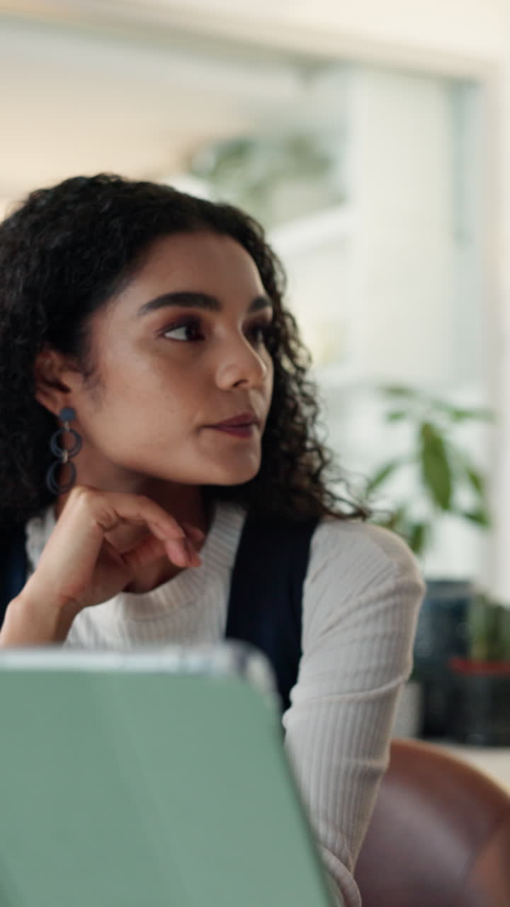 Two young professionals working together on a digital device