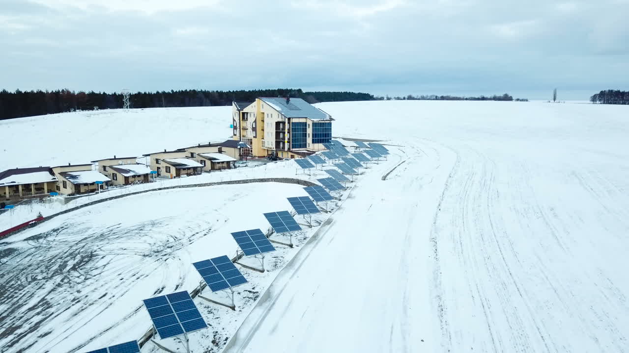 Complex with solar panels on the outskirts of the city. Rows of snow covered solar panels in a small solar power plant.