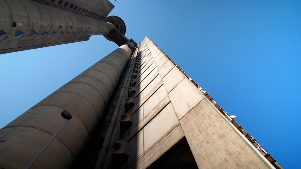 View of Belgrade’s Genex Tower, Serbia, showcasing brutalist architecture, geometric concrete design, and its iconic presence in the urban skyline low angle aerial drone view