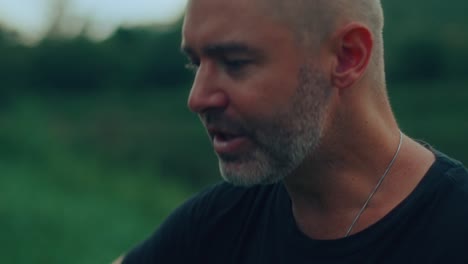 person playing an acoustic guitar outdoors