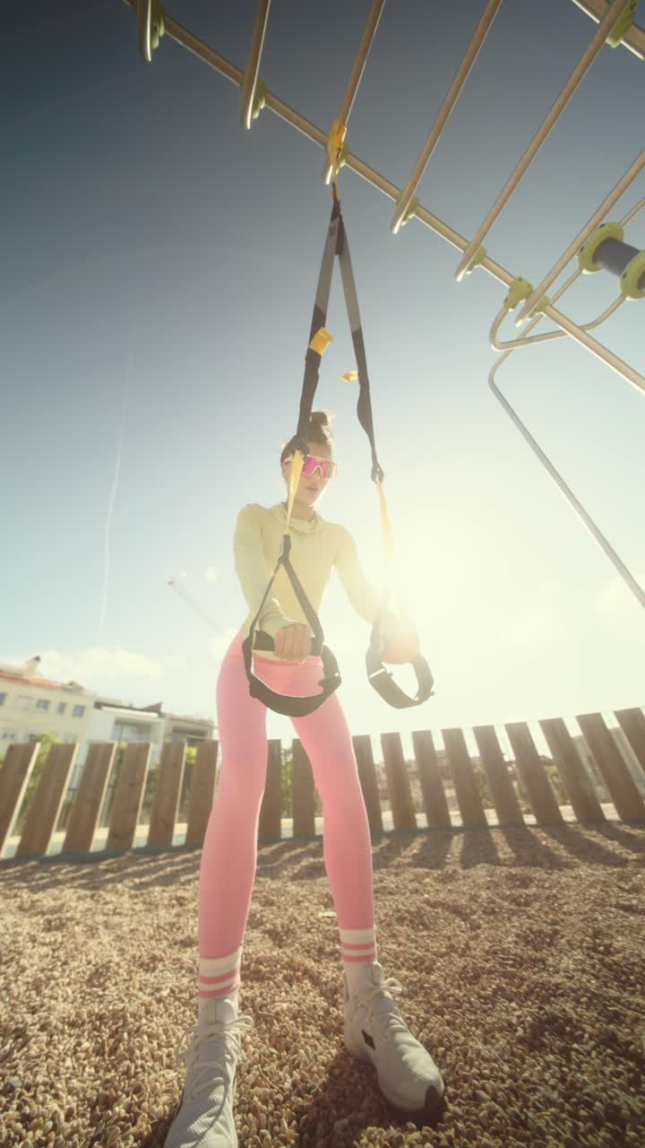 Woman working out outdoors with resistance bands