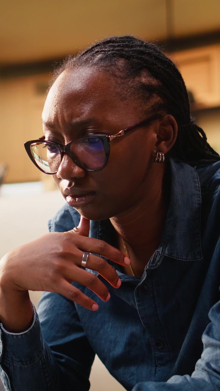 Vertical Video Close up of young woman frowning about ambiguous tasks at home