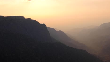 Pastel-coloured-hazy-twilight-sunset-over-Dana-Biosphere-Reserve-in-Rift-Valley,-rugged-mountainous-landscape-view,-Jordan,-Middle-East