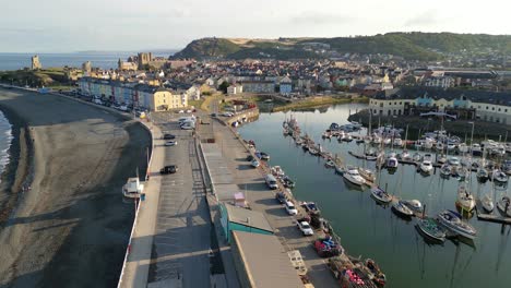 drone footage on a summer day in uk wales aberystwyth around the beach, harbour, sea side, clif and town front-2