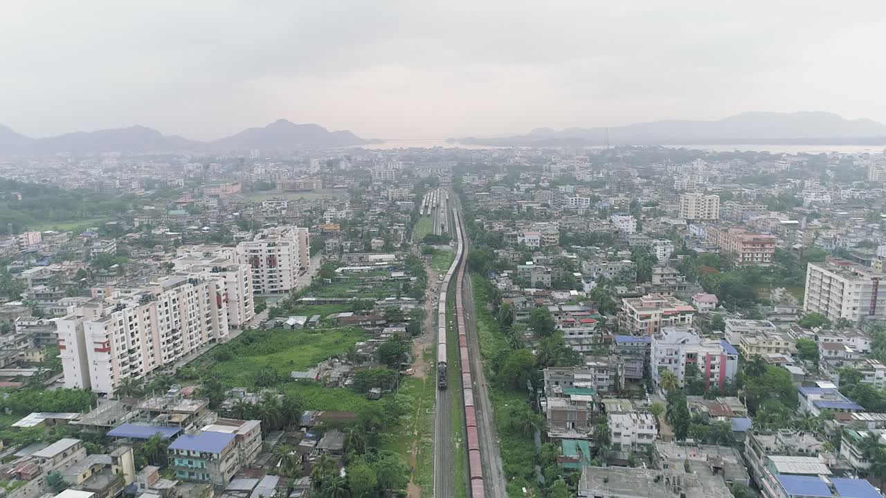 Great suburb neighborhood of town divided by railway where trains driving through, to transport passengers and wares