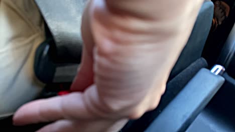 Hand-Unbuckles-Seat-Belt,-Slow-Motion-Close-Up